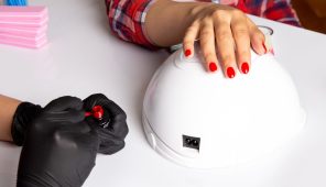 front-view-young-female-manicure-with-black-gloves-doing-manicure-white_140725-24262